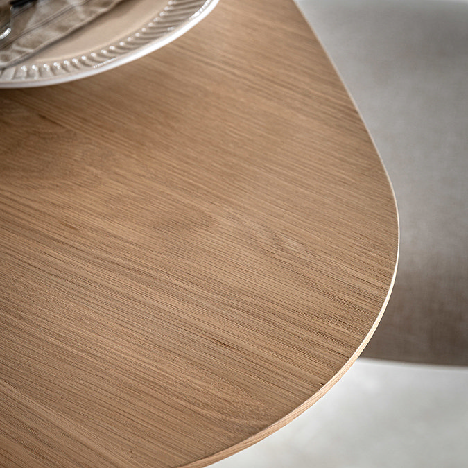 close up on smooth curved edge of light oak dining table