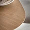 close up on smooth curved edge of light oak dining table