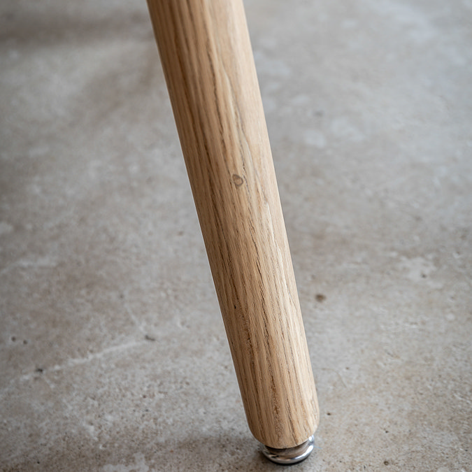 close up on smooth slim wood legs of dining table