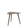 image cut out on white background of dark oak three legged triangular table