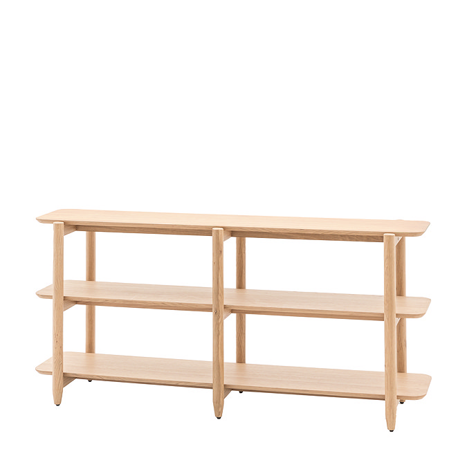 image cut out on white background of wide oak shelving unit with four shelves