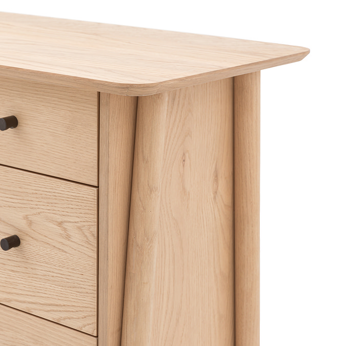 image cut out on white background of 3 drawer chest with long angled legs, close up on smooth top with rounded edge