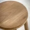 close up on round oak seat of bar stool with wood grain effect