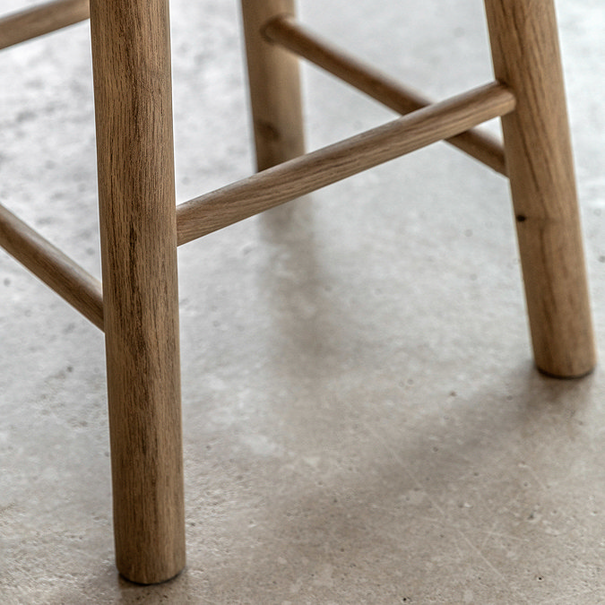 close up on wooden legs with slats of oak stool