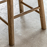 close up on wooden legs with slats of oak stool