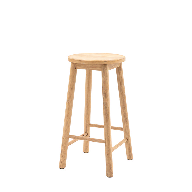 image cut out on white background of oak stool with round seat and four legs with two slats on each side