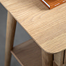 close up on wooden top of light oak bedside table with smooth curved edge