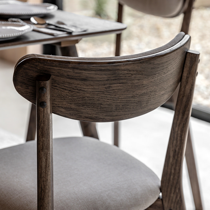 close up image of dark wood of gently curved dining chair back rest