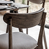 close up image of dark wood of gently curved dining chair back rest