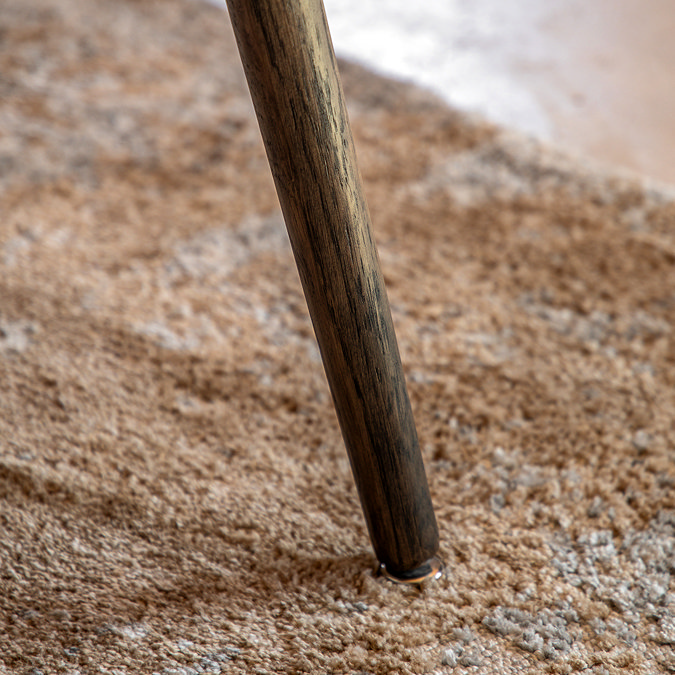 close up on thin leg of smoked oak triangular side table