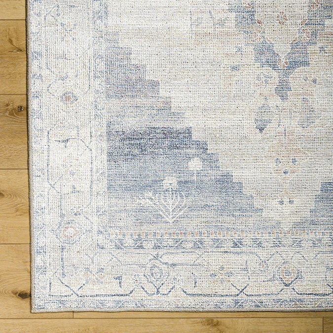 close up image of blue and white distressed vintage rug, focus on colour and pattern
