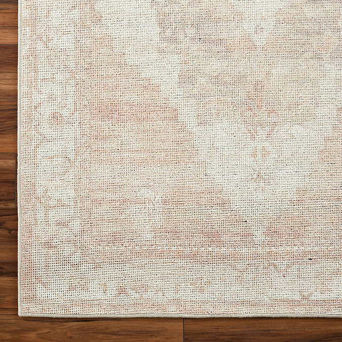 close up image of tan and ivory vintage rug, focus on colours and textures
