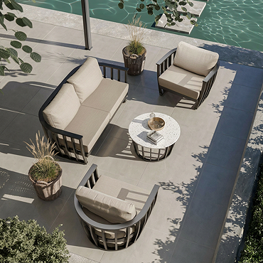 close up on rounded contemporary open frame garden armchair with plush cushions