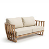 cut out of 2-seat garden sofa with plush cream cushions and teak arms