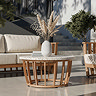 close up image taken from eye level of teak coffee table, with sofa in the background