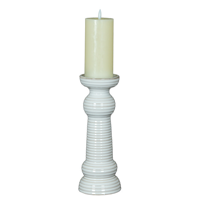 image cut out on white background of medium sized ceramic ribbed candle holder with battery operated candle