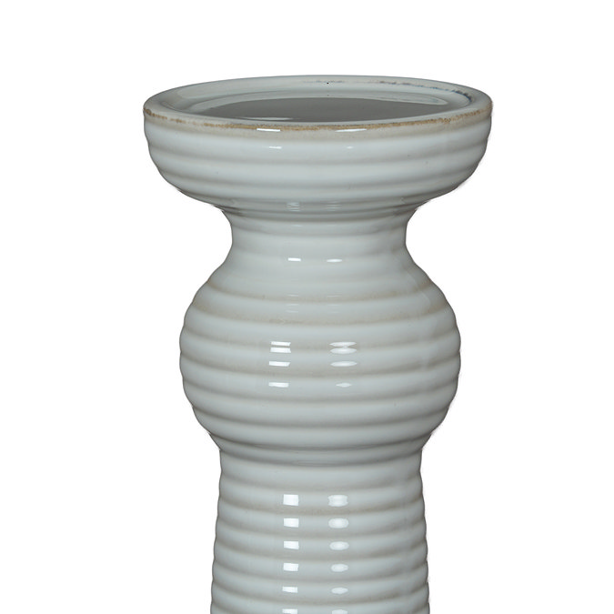 close up image cut out on white background of ceramic ribbed candle holder without candle to show top