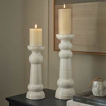 image cut out on white background of medium sized ceramic ribbed candle holder with battery operated candle