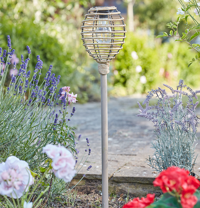 image taken during daylight of faux rattan stake light with beehive shaped top