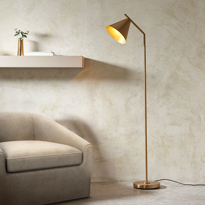 image of tall slim light in corner of living room directing warm light onto an armchair