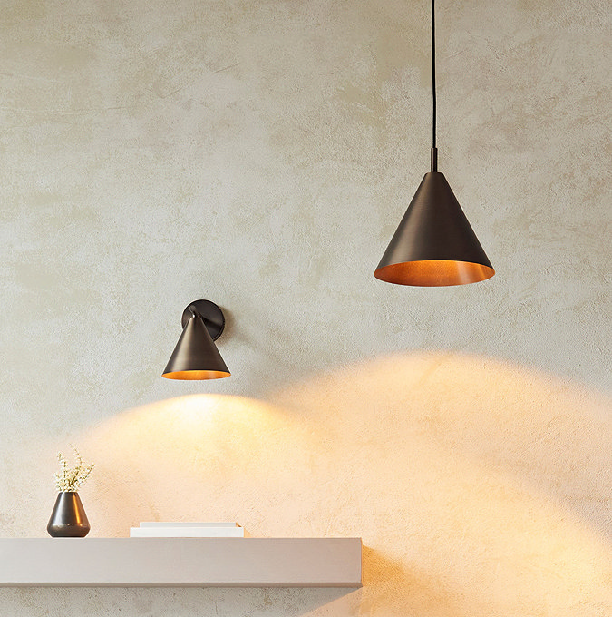 close up of antique bronze ceiling light hanging next to matching wall light