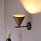 image of bronze conical wall light turned upwards to demonstrate adjustable head