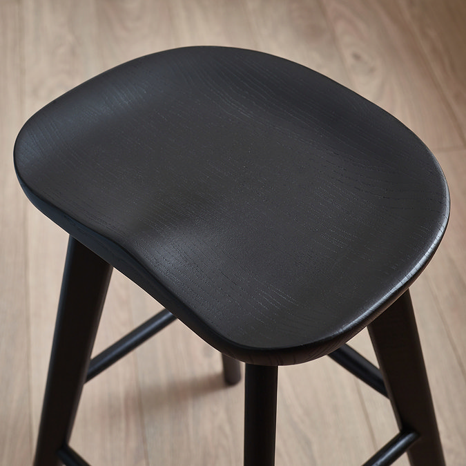 close up image taken from above of black oak bar stool