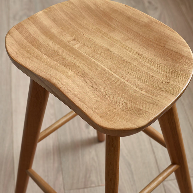 close up image of smooth oak wooden surface of bar stool top