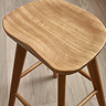 close up image of smooth oak wooden surface of bar stool top
