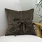 Bow cushion in chocolate on chair image 1