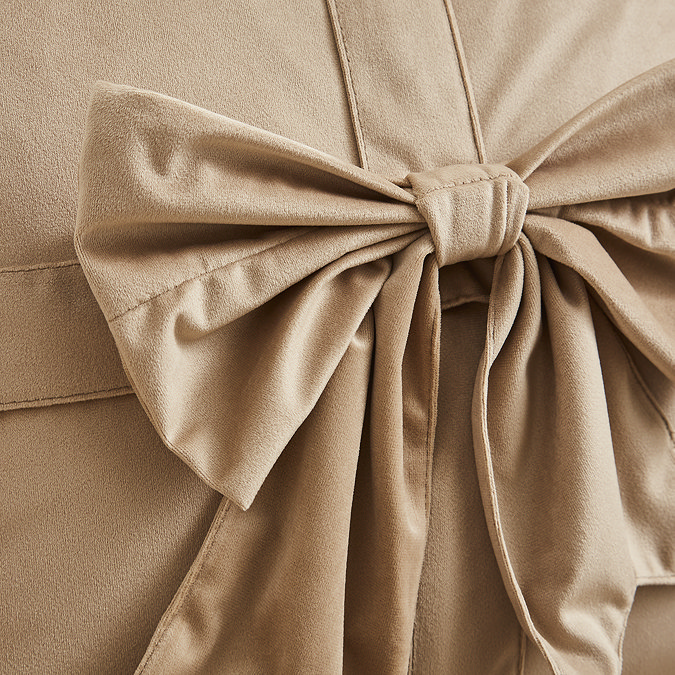 close up image of natural coloured cushion with velvet bow