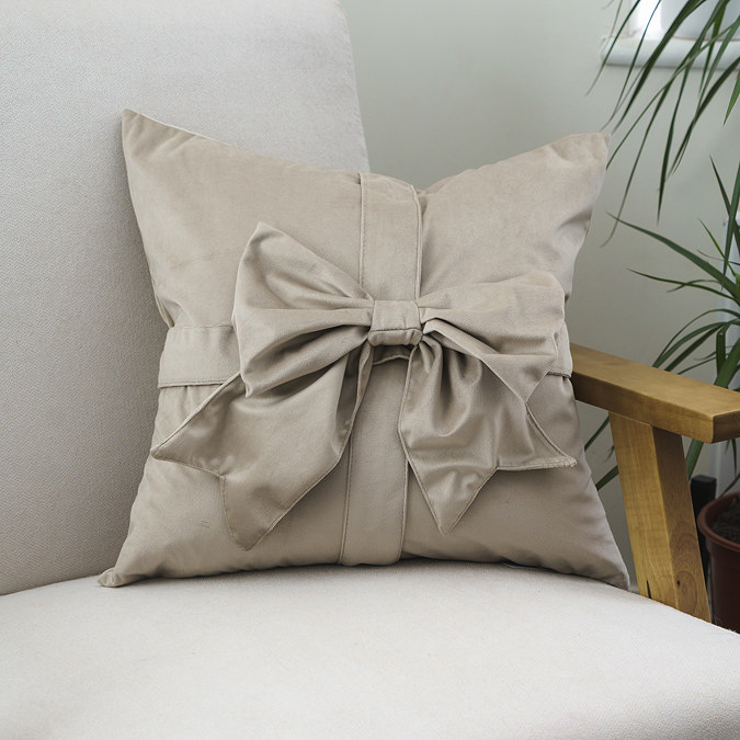 Natural bow cushion on chair image 1