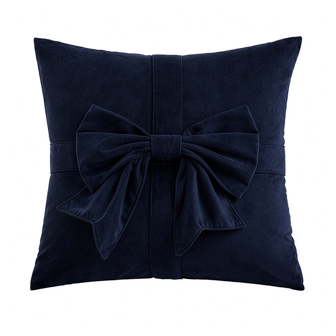 image cut out on white background of navy blue square cushion with bow on the front