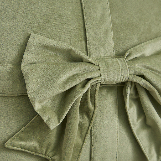 close up image of sage green velvet bow cushion