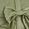 close up image of sage green velvet bow cushion