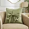 image of sage green cushion with front bow detail on a cream armchair