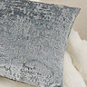 close up image of distressed ice blue cushion
