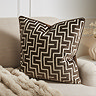 Geo cushion in chocolate brown on settee image 1