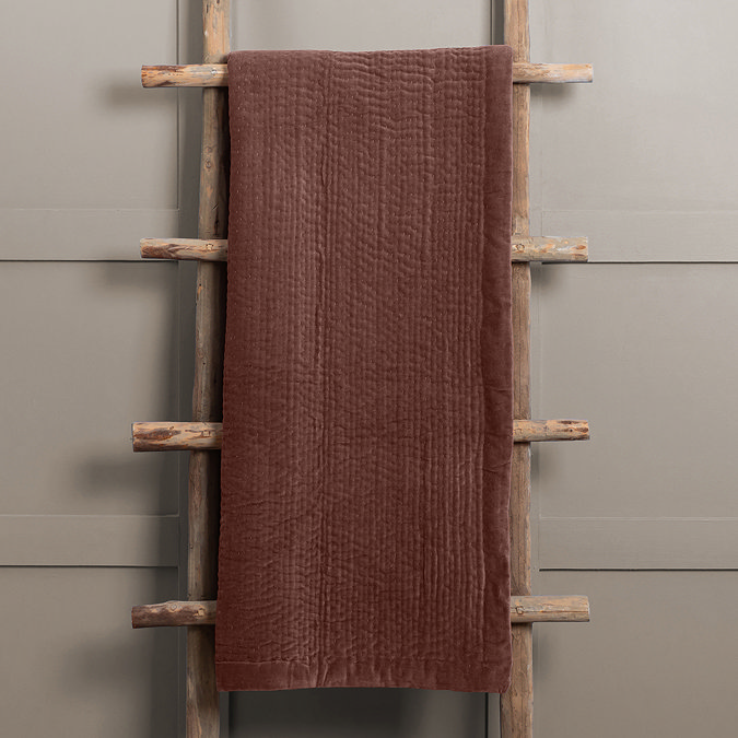 persimmon throw draped over rustic ladder