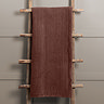 persimmon throw draped over rustic ladder