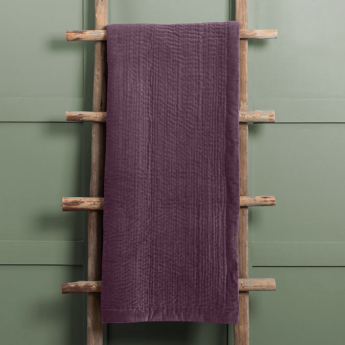 plum coloured velvet throw draped over rustic ladder