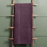plum coloured velvet throw draped over rustic ladder