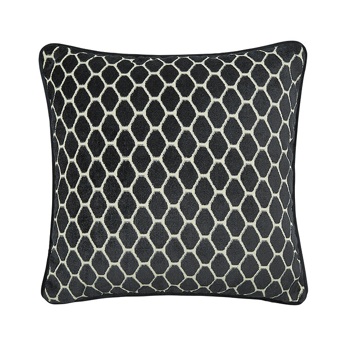 image cut out on white background of black cushion with honeycomb pattern