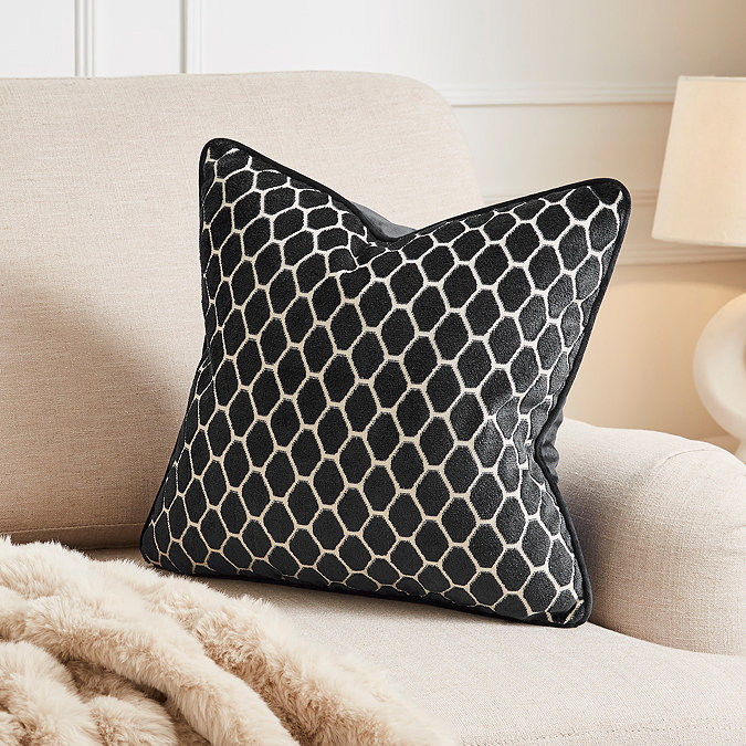 image of black cushion with honeycomb pattern on cream sofa