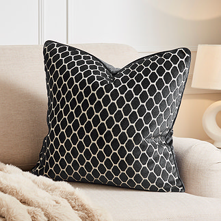 image of 55x55cm black cushion with honeycomb pattern on cream sofa