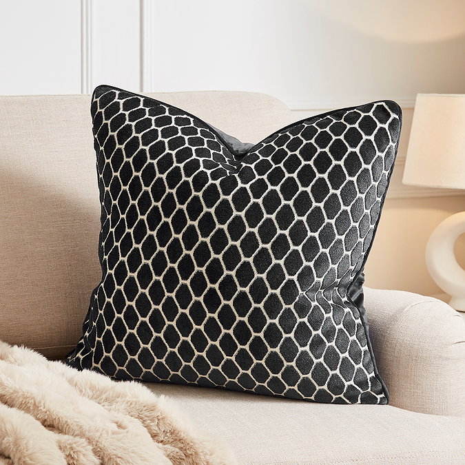 image of 55x55cm black cushion with honeycomb pattern on cream sofa