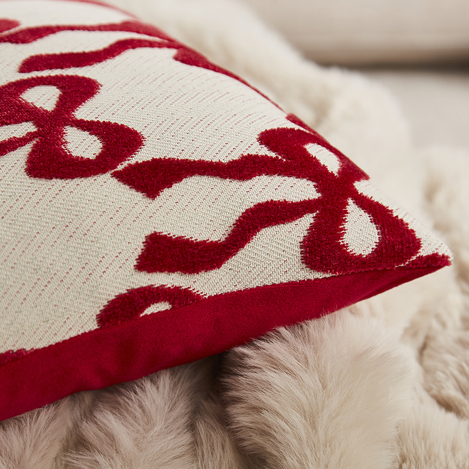 close up on red bow pattern of natural cushion