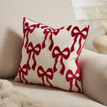 close up on red bow pattern of natural cushion