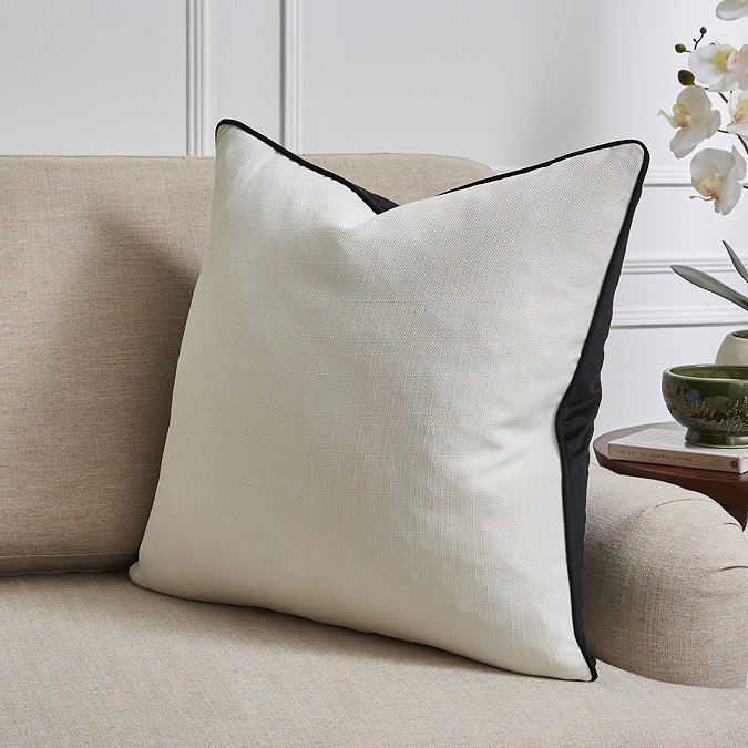 Sofia piped Black cushion on settee in black 55x55 image 1