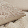 close up image on corner of natural coloured cushion